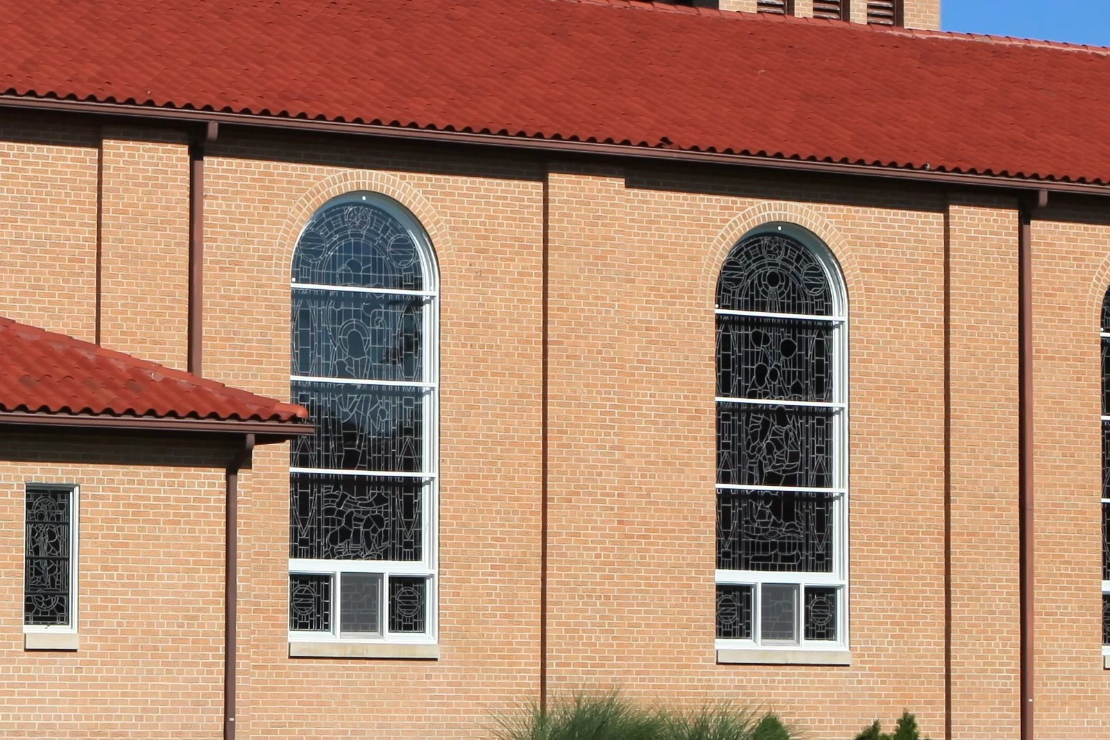 Stained glass window in wood frame showing protective glazing details